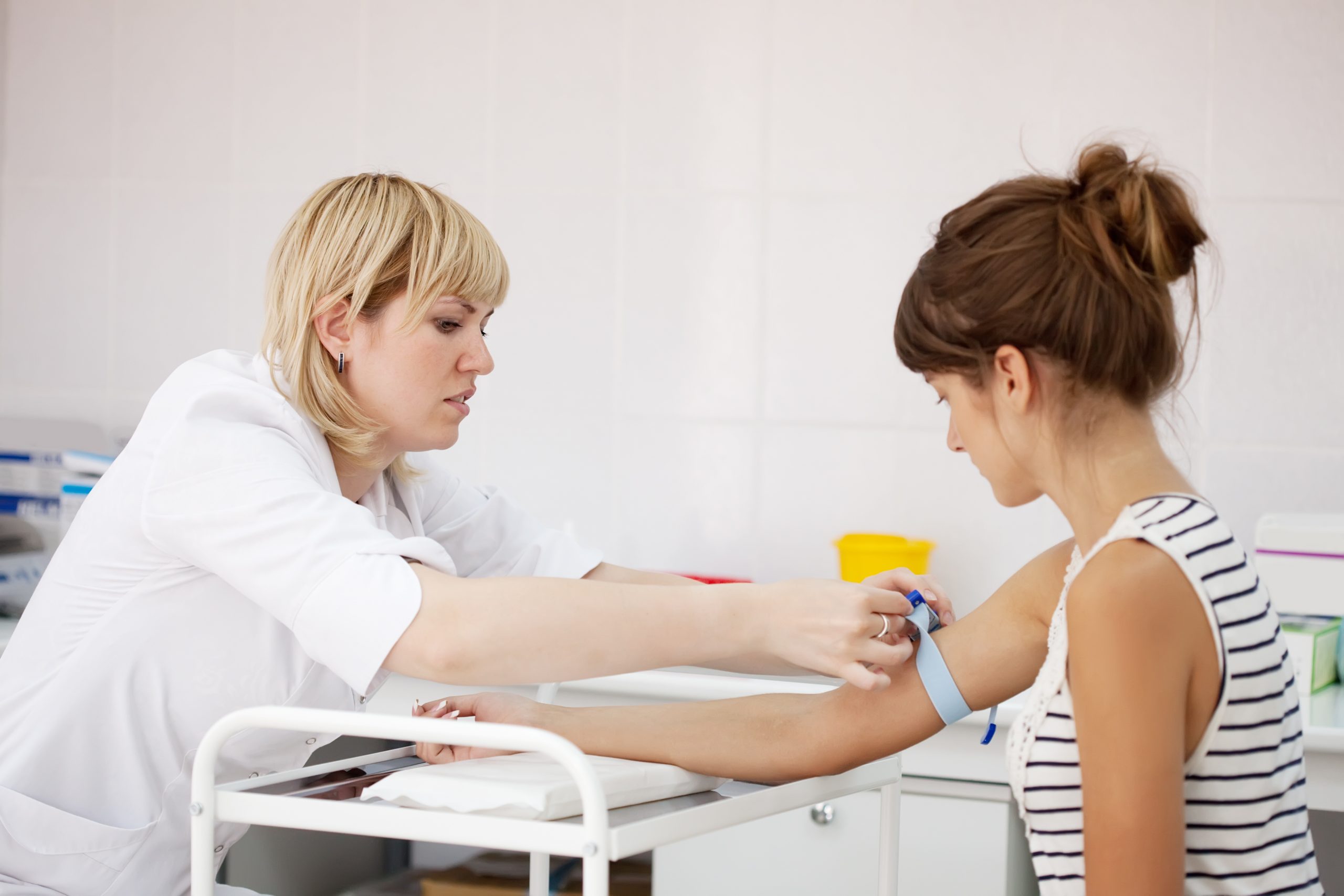 Nurse taking blood in a clinical trial